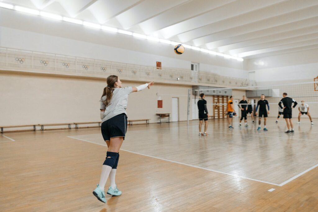 a woman in sports wear serving the ball